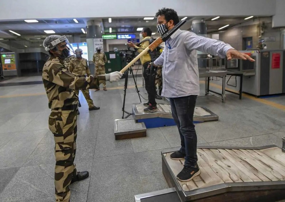 New Delhi: A CISF personnel uses a modified metal detector to ensure social distancing as part of preparations ahead of the resumption of Delhi Metro services from Sept. 7 with restrictions, at Rajiv Chowk station in New Delhi, Thursday, Sept. 3, 2020. (PTI Photo/Ravi Choudhary)